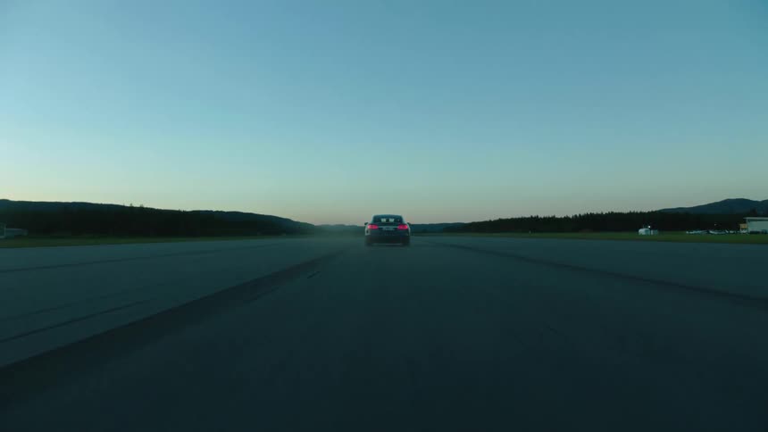 A car drives down an empty road