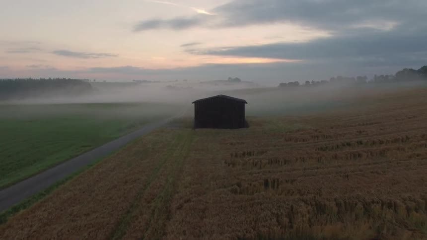 Moving over a field towards a barn