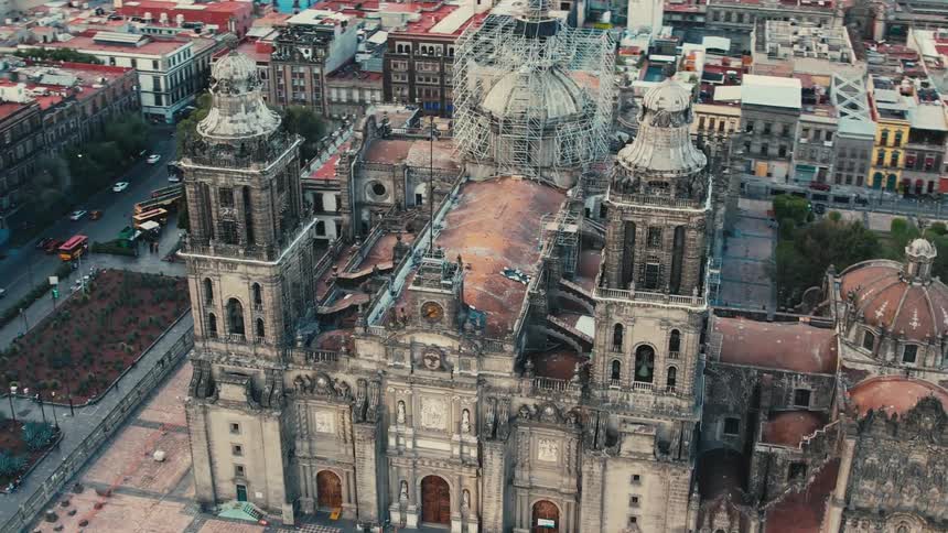 Cathedral with towers and domes stands over surrounding buildings