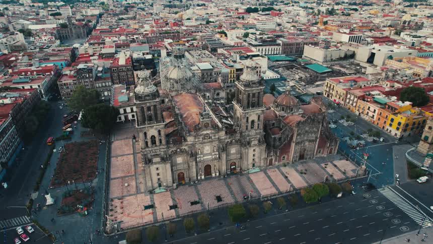 Aerial view of a building with tall spires and surrounding buildings