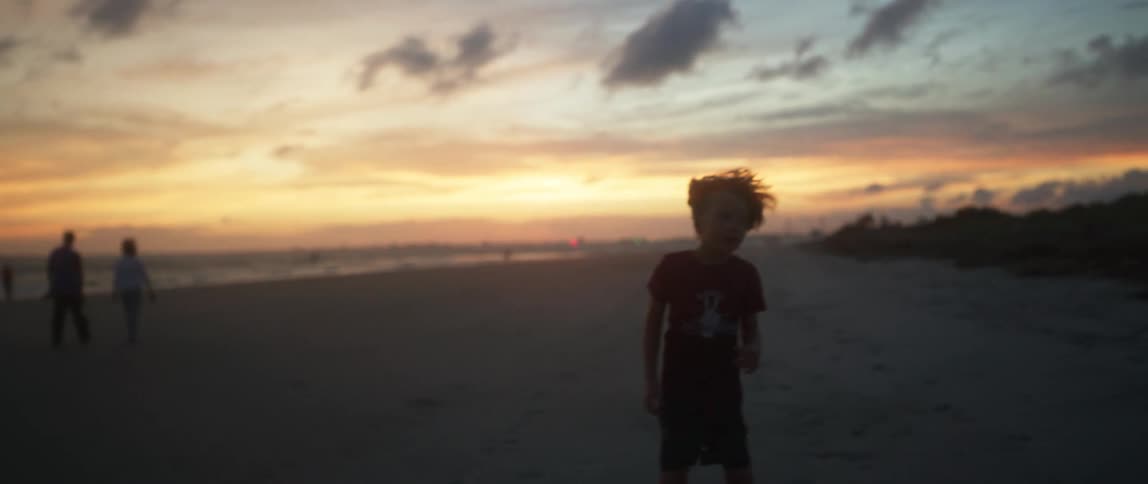 A child is running on the beach