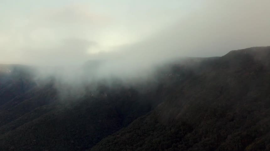 Low lying clouds obscure mountain slopes