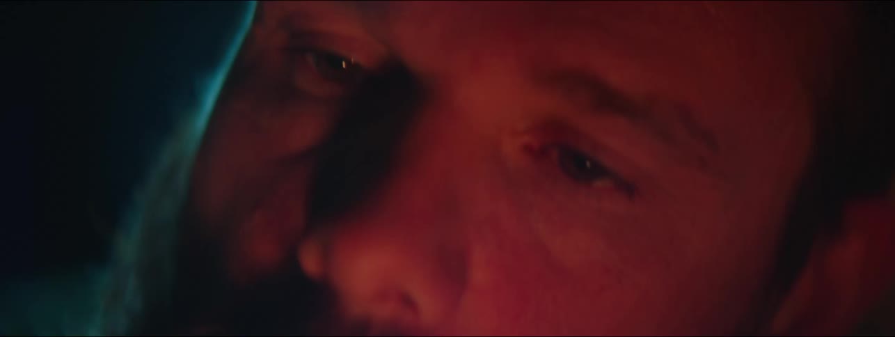 The fire is reflecting off the mans face