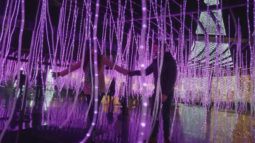 Couple playing with light installation at the park