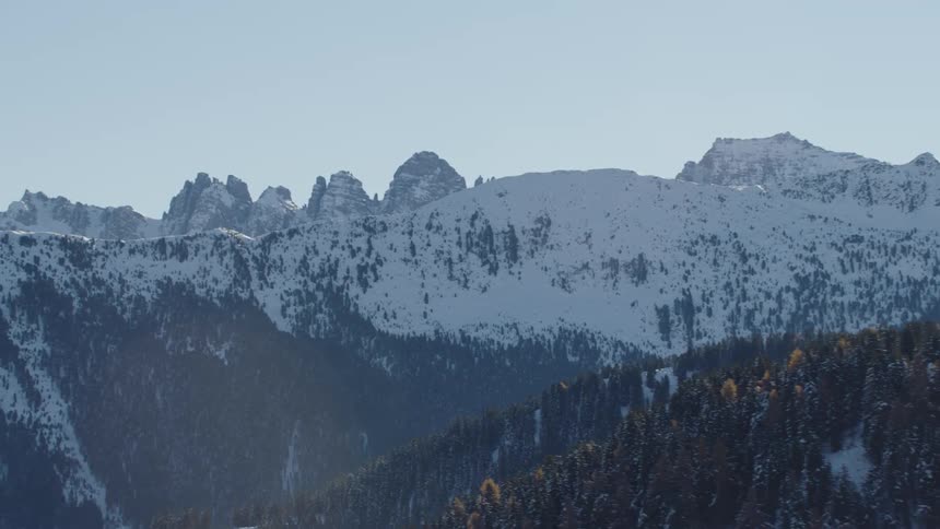 The tall mountains have a light fog on top