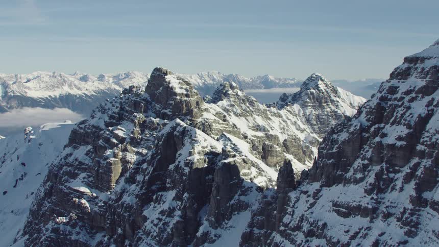A mountain range is covered in snow