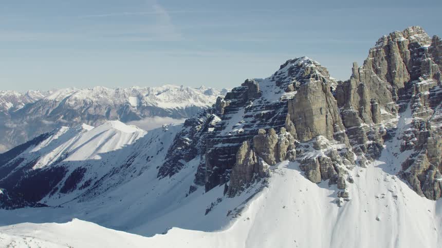 The tall mountains are covered in snow