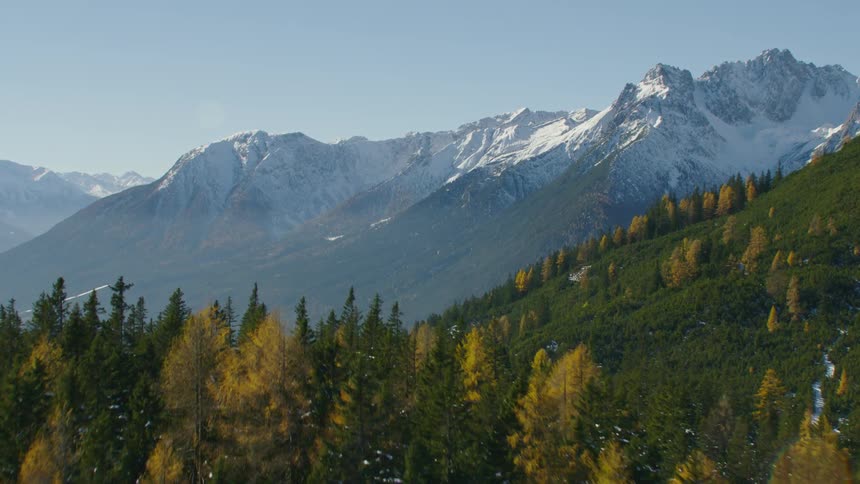 Aerial view of distant snowy mountain ranges and valley