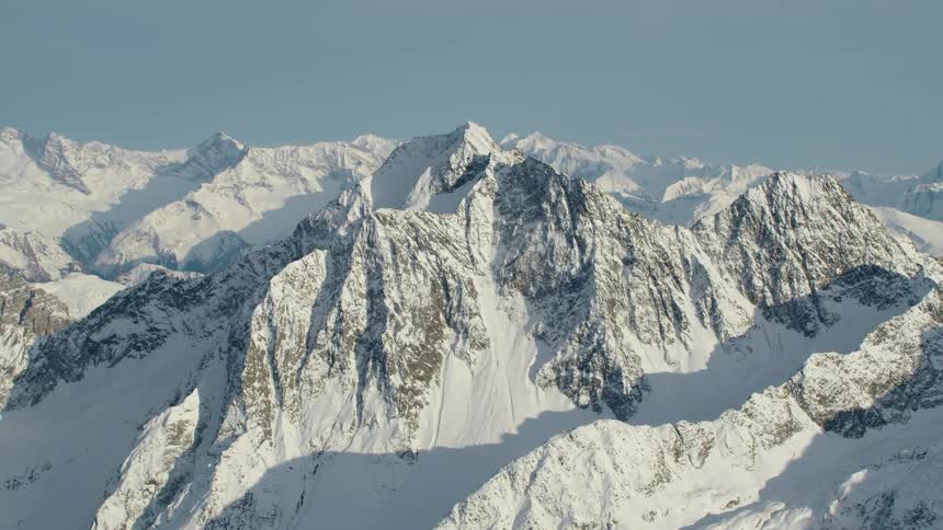 A heavy blanket of snow covers a mountain range