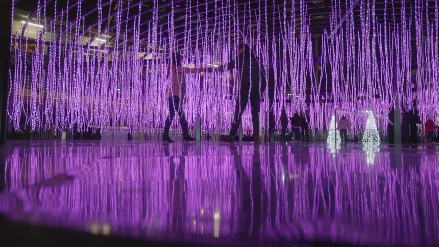 Dancers move around on the purple stage