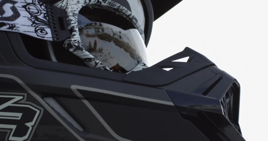 A person wearing a helmet looks around