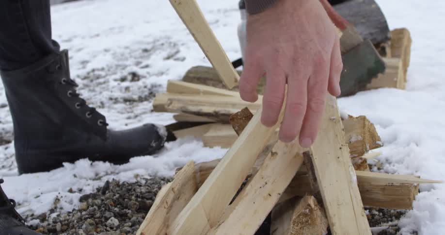 A person building a fire