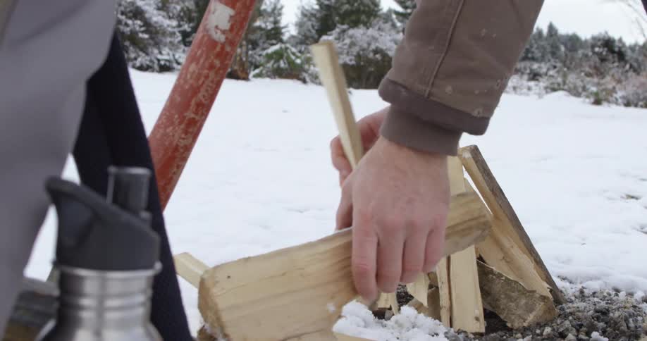 A person building a fire