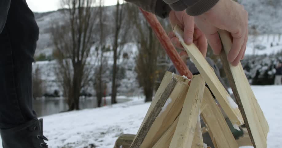 A person building a fire
