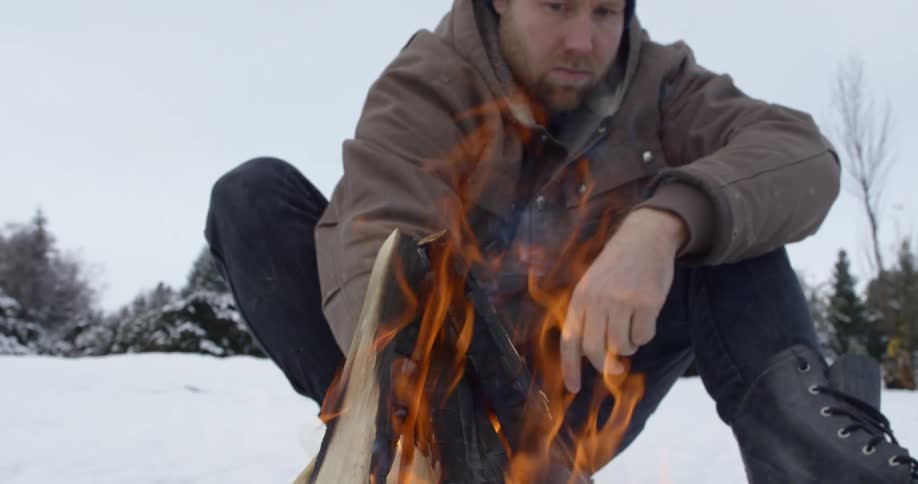 A man is making a fire