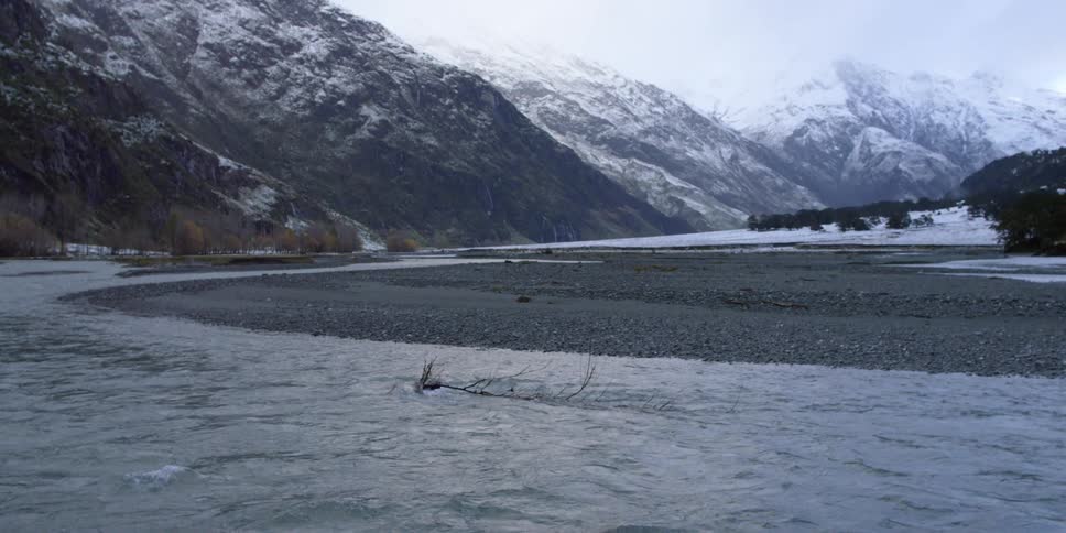 A river flowing aside a mountain range