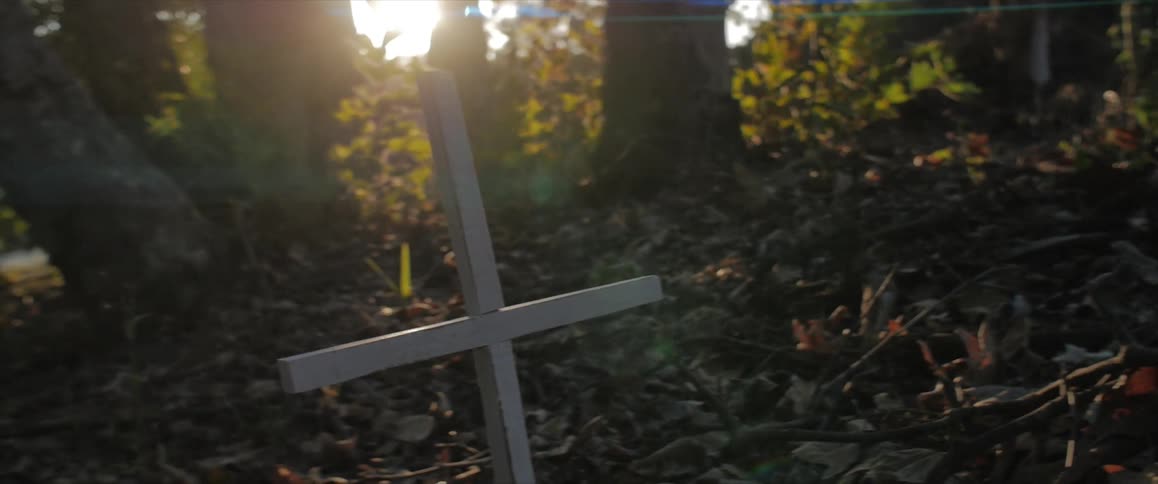 A small wooden cross in the forest