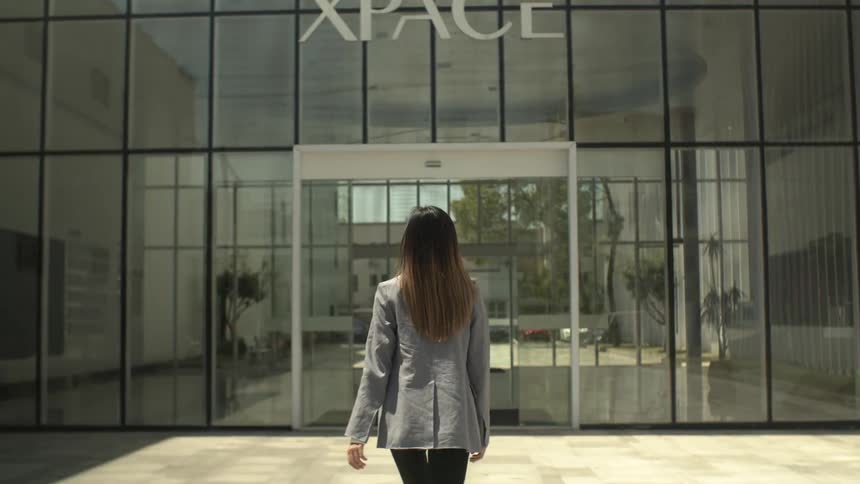 A woman walks towards the entrance of the store