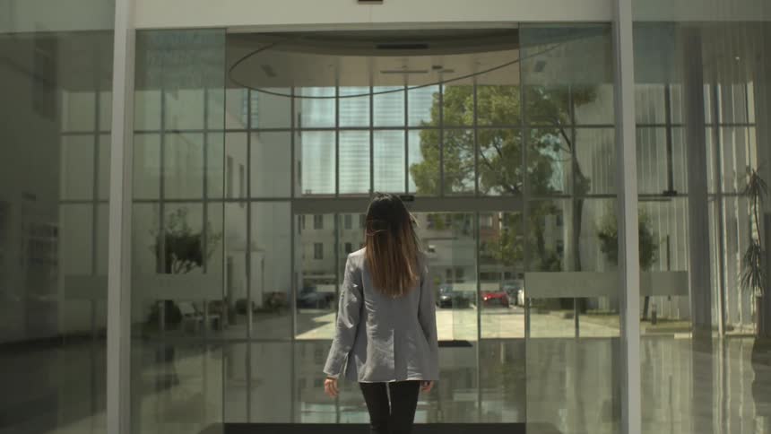 Female walking into building