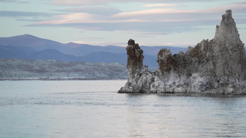 A rock formation stands in a waterway