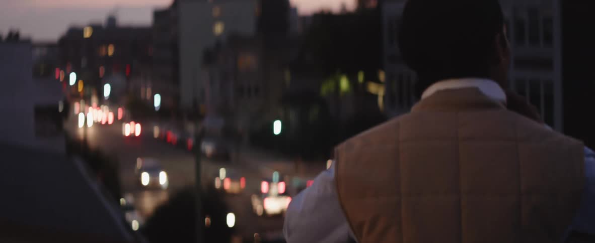 A person walking around outdoors putting on headphones