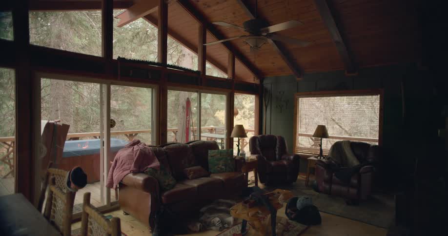 Dimly lit living room on a house in the forest on a calm day