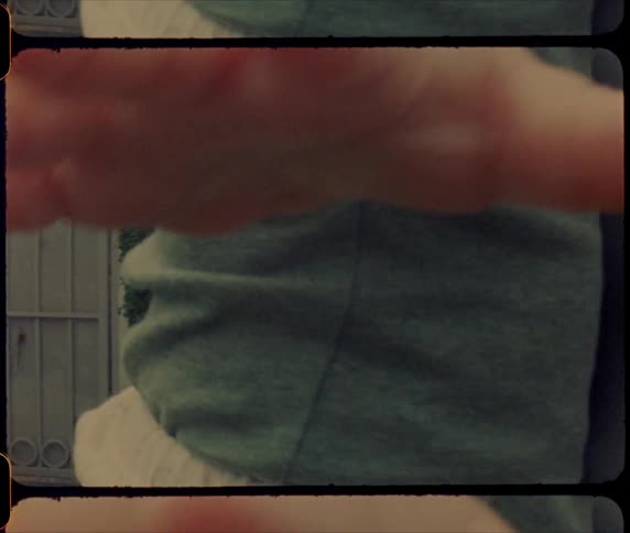 A man holds his baby son who is reaching his hand out