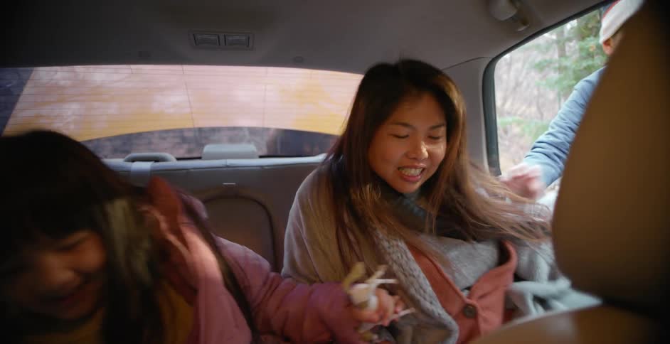 A mother and her children getting into a car