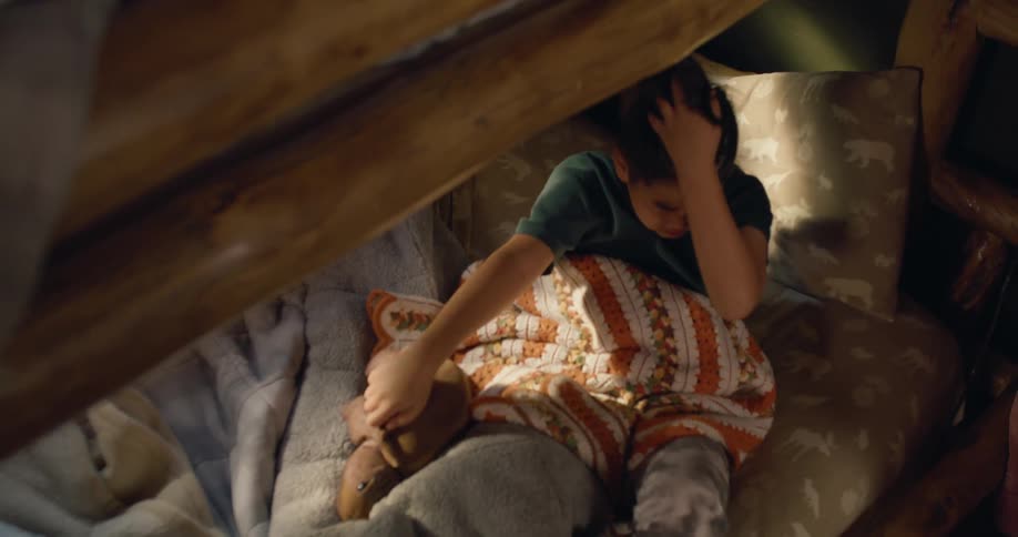 A boy and girl sleeping in bunk beds