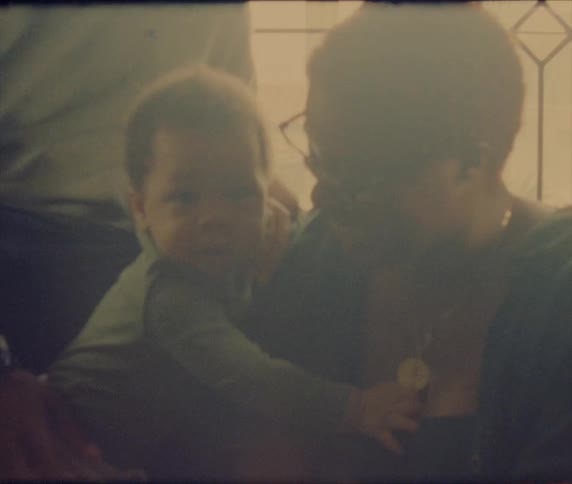 Black child hugging people
