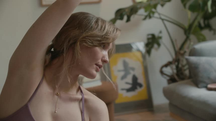 A woman is doing yoga at home
