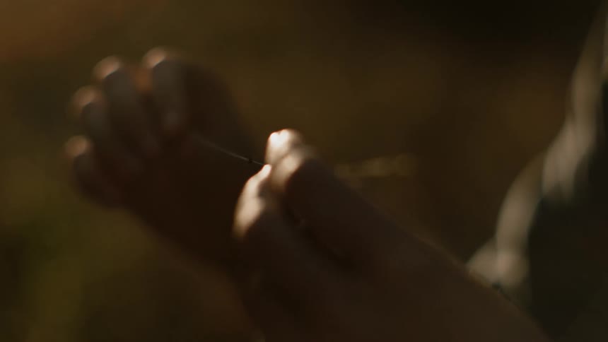 A view of someone holding straw in their hands outdoors