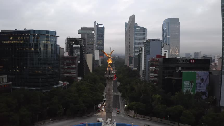 An aerial view of a city with a statue in the middle