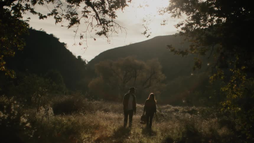 Couple walking into forest