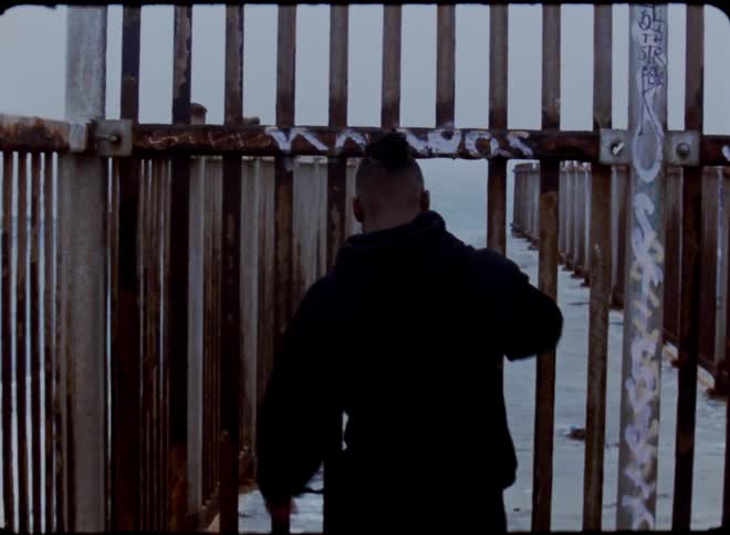 A man walks through a gated off pier