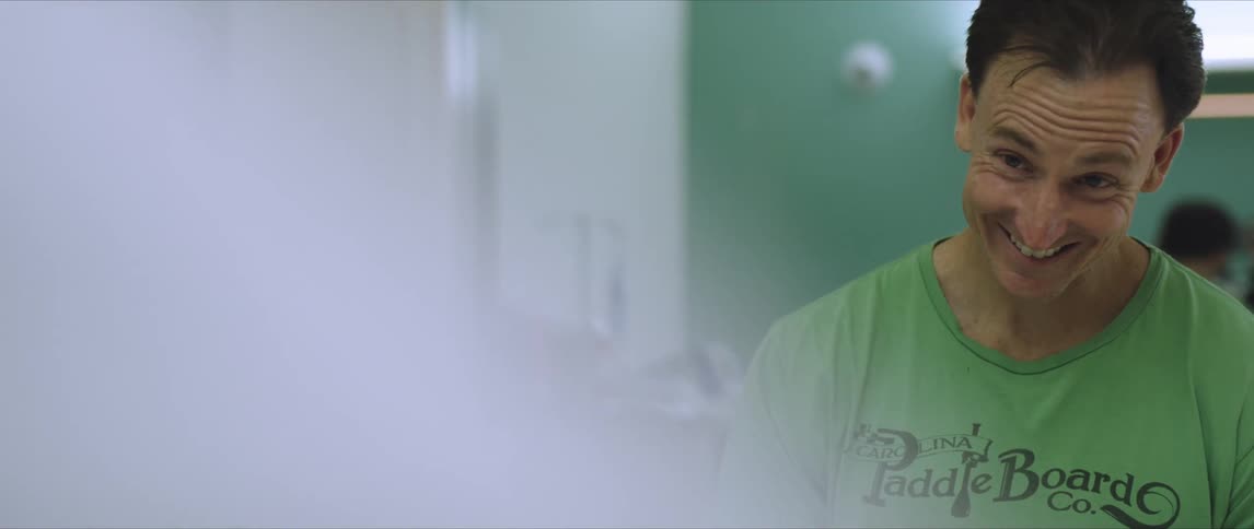 A man standing in a room and smiling