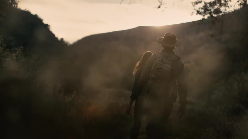 A man and woman walking around outdoors