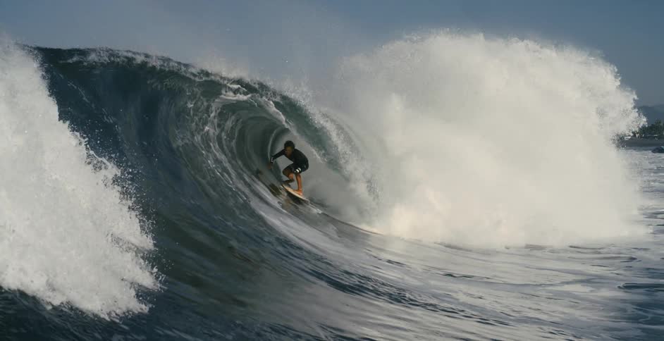 A man surfing on a large wave