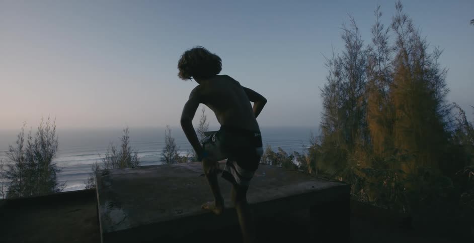 A person running and jumping onto a concrete table