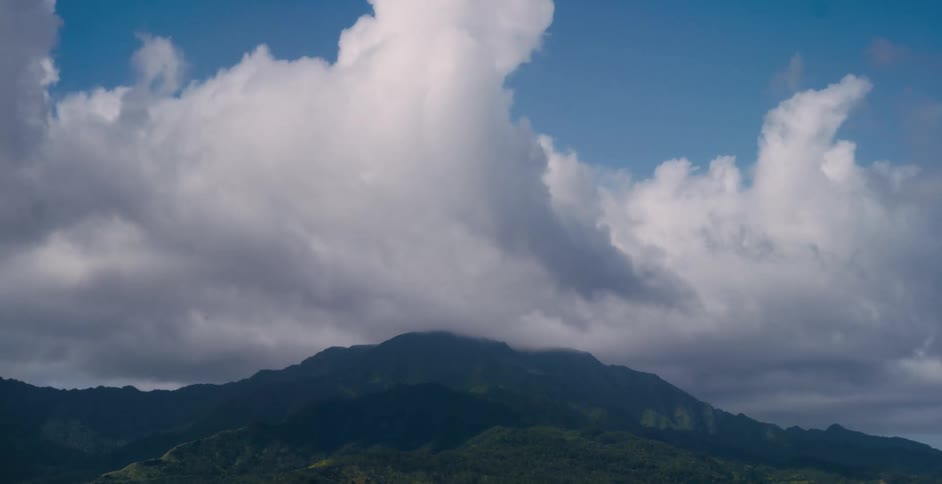 Clouds rapidly move over a mountain