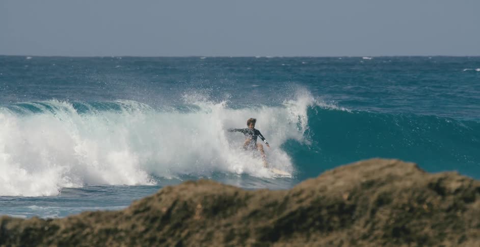 Teenager surfing a wave