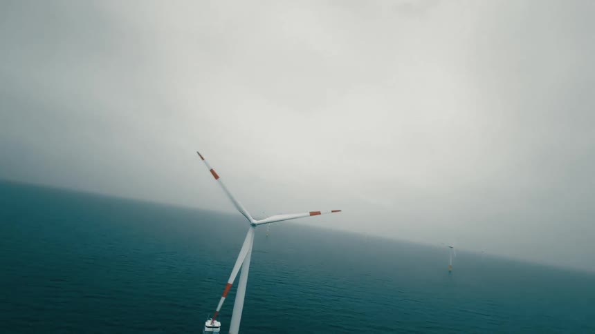 Aerial view of an offshore wind turbine in the water