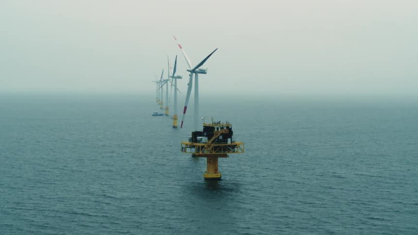 Turbines spinning on a windfarm in the ocean