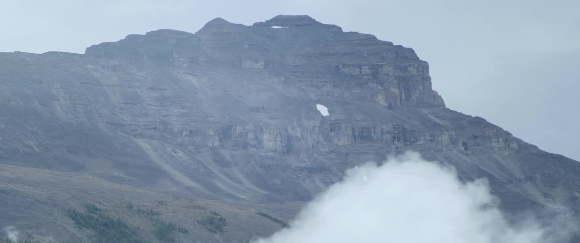 Dense clouds surround a mountain peak