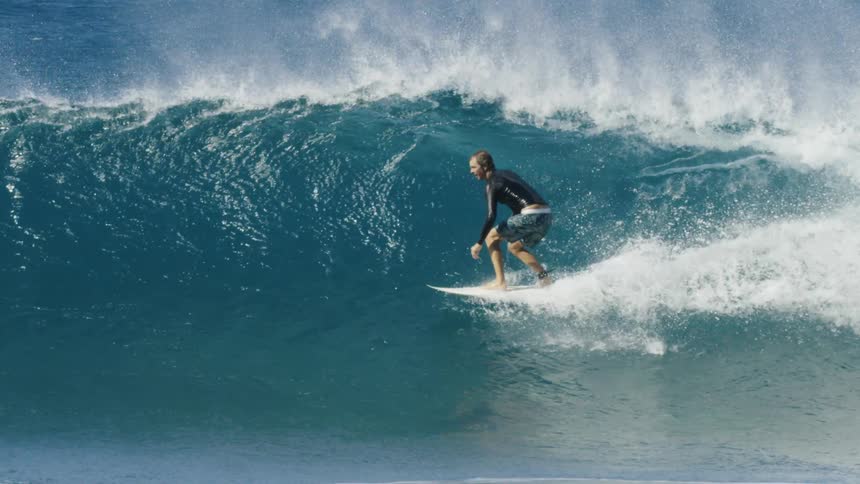 Young man riding some big waves in the ocean
