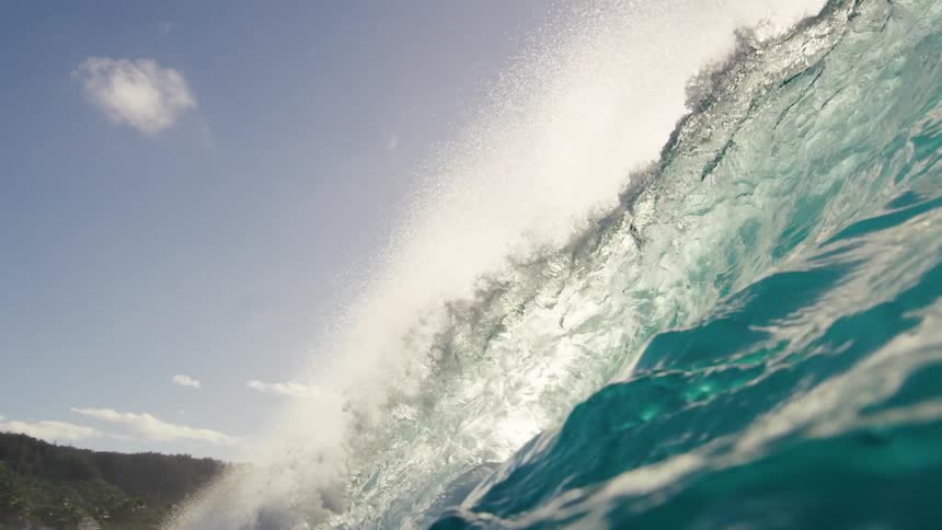 A tall waves washes onto the beach