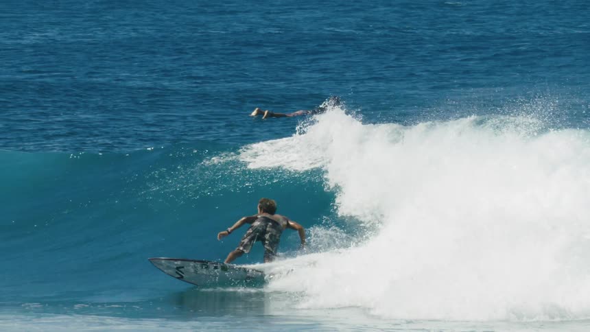 People are surfing on ocean waves during the daytime
