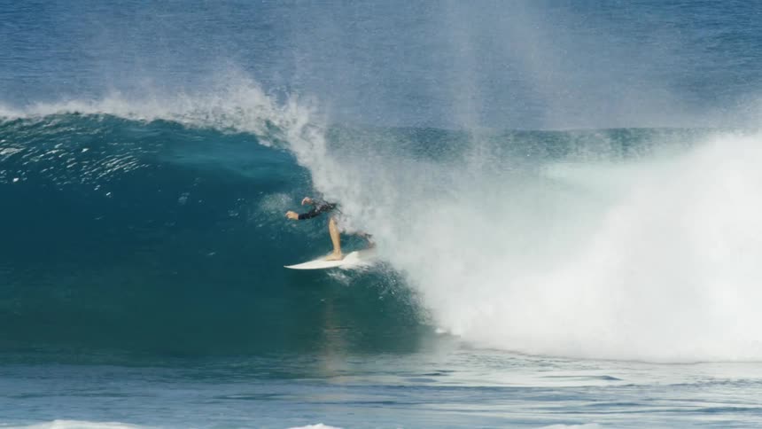 A person surfing on a large wave