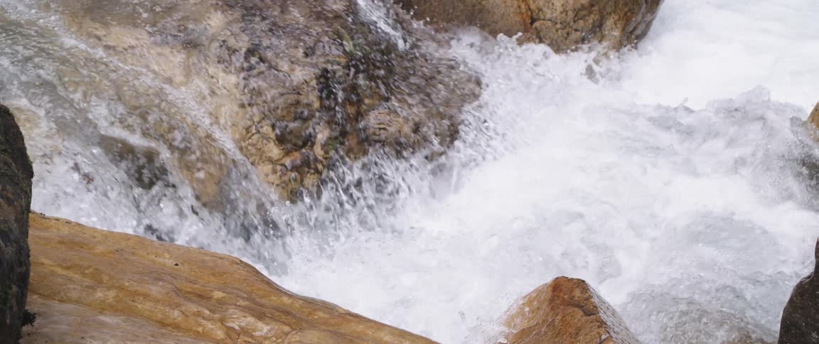 Water is flowing down a waterfall during the day