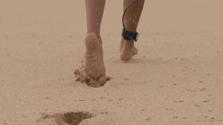 A person is running on the coast of a beach